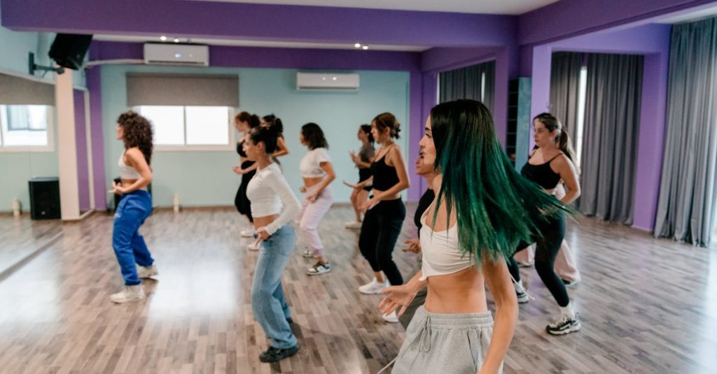 Energetic group dance session in a vibrant studio with participants enjoying a workout.